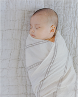 Baby wrapped in fair trade crafted swaddle