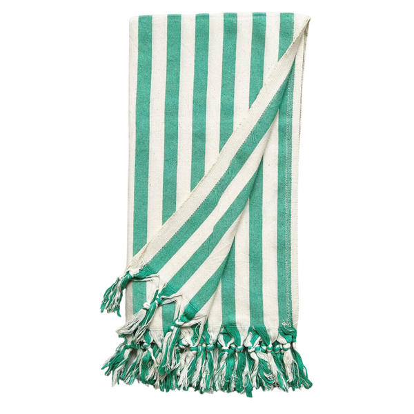 A cotton beach towel with large green stripes and a tassel fringe.