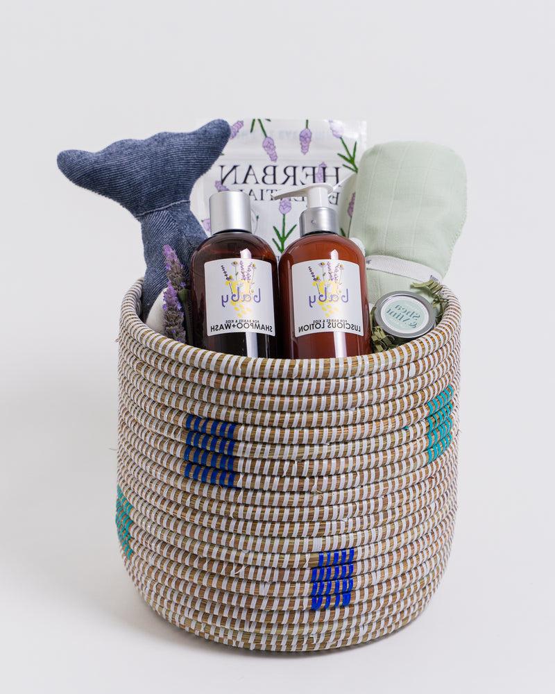 Fair trade woven basket filled with baby bedtime accessories